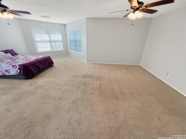 bedroom with visible vents, baseboards, light colored carpet, and a ceiling fan