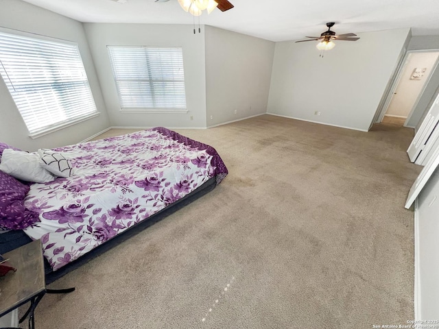 carpeted bedroom featuring baseboards and ceiling fan