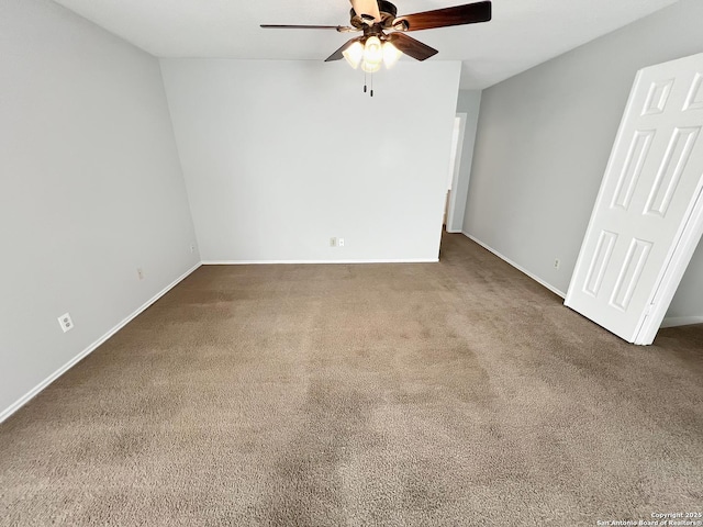 interior space featuring a ceiling fan, carpet, and baseboards