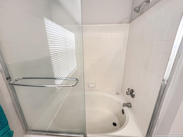 full bath featuring combined bath / shower with glass door