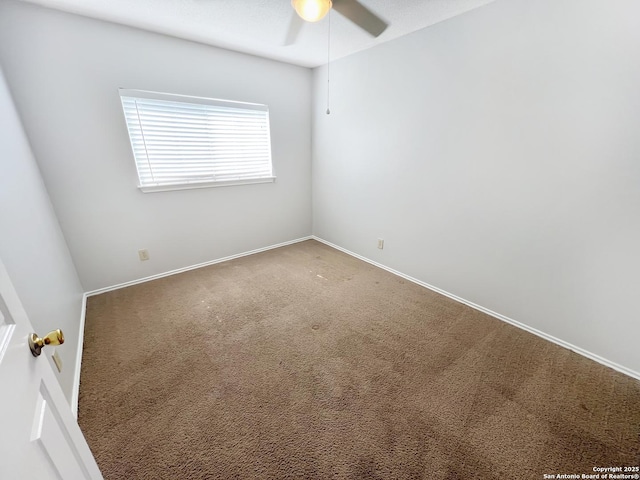 carpeted empty room with baseboards and ceiling fan