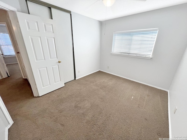 unfurnished bedroom with a closet and carpet