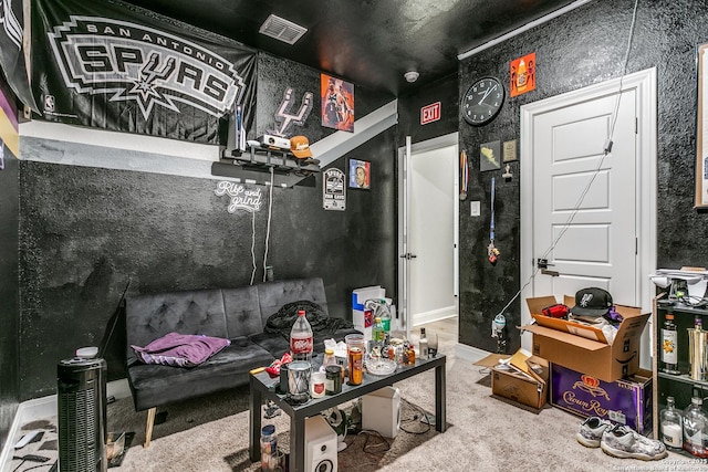 living area featuring visible vents and carpet flooring