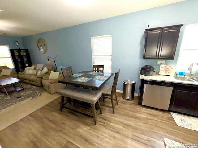 dining room with light wood-style flooring and baseboards