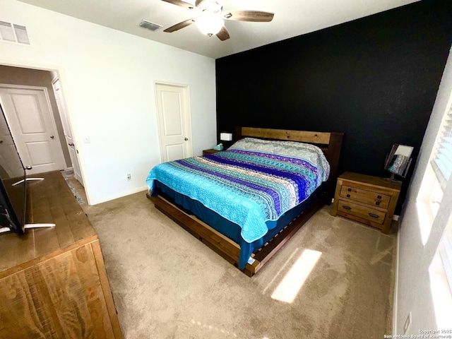 bedroom featuring visible vents, carpet flooring, baseboards, and a ceiling fan