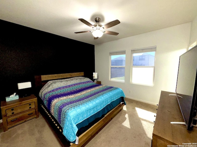 carpeted bedroom with baseboards and a ceiling fan