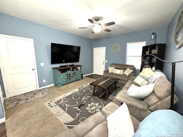 carpeted living room with baseboards and ceiling fan