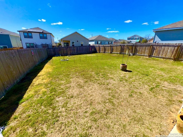 view of yard featuring a residential view and a fenced backyard