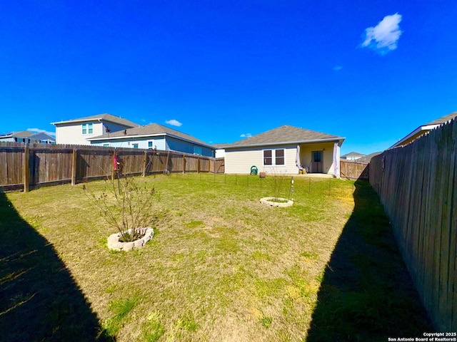 view of yard with a fenced backyard