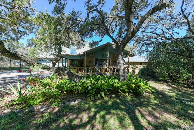 view of yard featuring a garage and covered porch