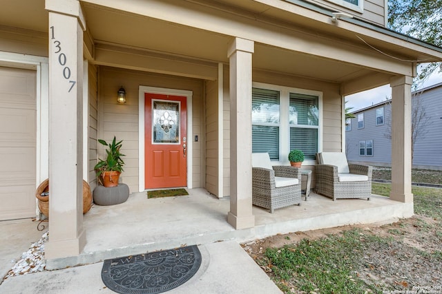 view of exterior entry featuring covered porch