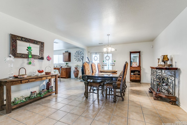 dining area with a notable chandelier and light tile patterned floors