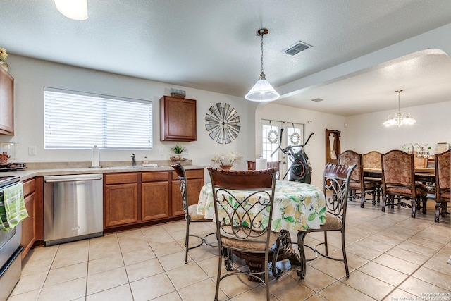 dining area featuring light tile patterned floors, a notable chandelier, and plenty of natural light