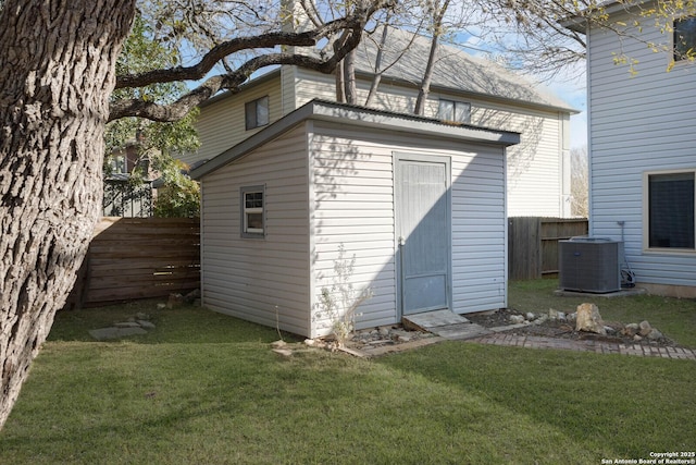 view of shed with cooling unit and a fenced backyard