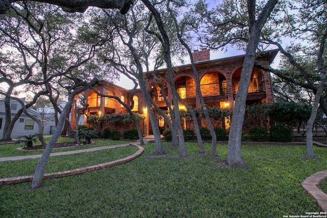 view of front of property with a chimney and a front yard