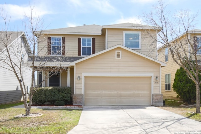 traditional home featuring concrete driveway and an attached garage