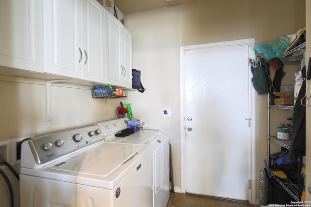 washroom with cabinet space and washer and dryer