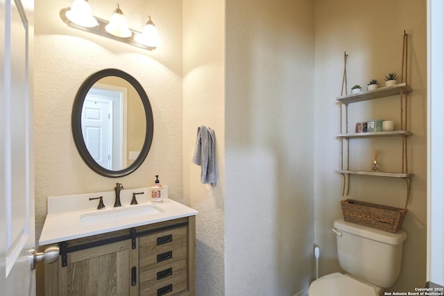 bathroom featuring toilet and vanity