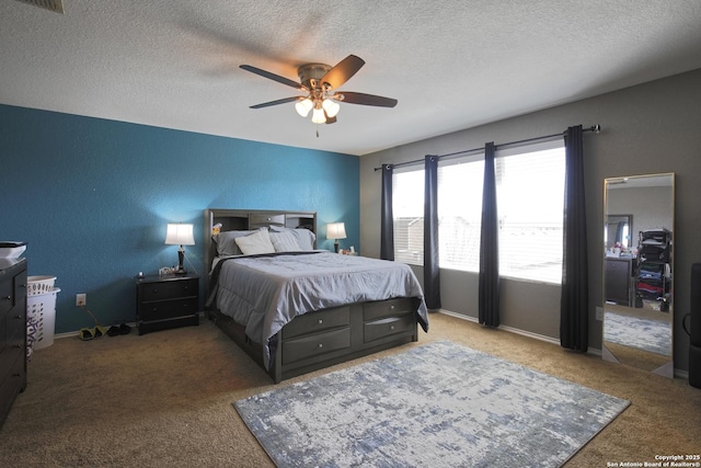 bedroom with baseboards, a textured ceiling, ceiling fan, and a textured wall