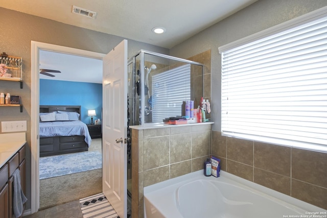 bathroom featuring visible vents, connected bathroom, a shower stall, a bath, and vanity