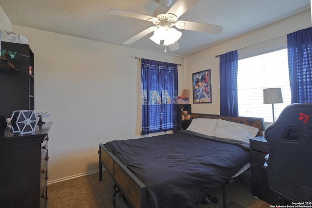 carpeted bedroom with baseboards and ceiling fan