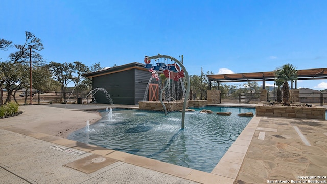 view of swimming pool featuring fence