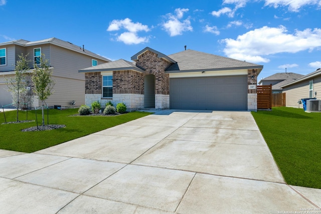 view of front facade featuring stone siding, central AC unit, driveway, and a front lawn