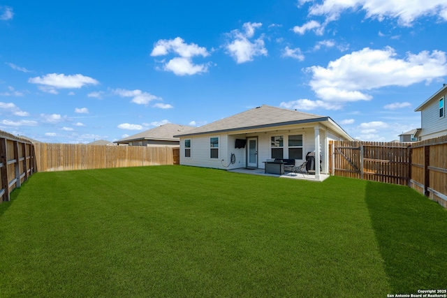 back of property featuring a patio area, a lawn, and a fenced backyard