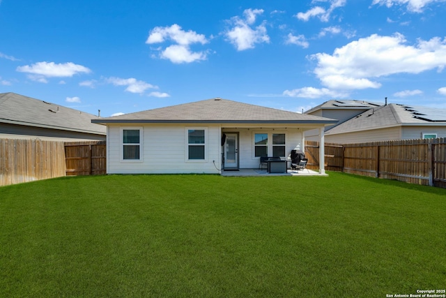 back of house featuring a patio area, a fenced backyard, and a yard