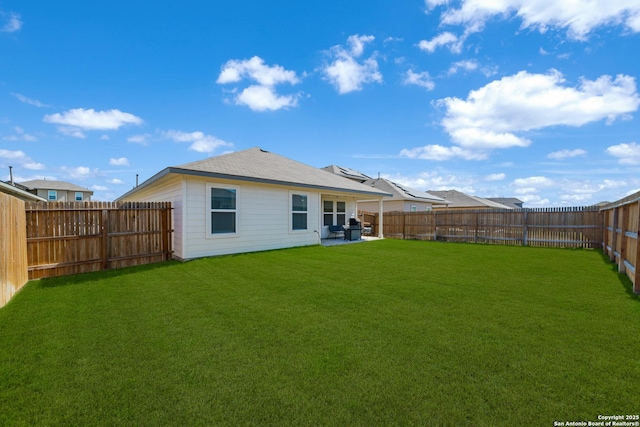 back of house featuring a patio area, a lawn, and a fenced backyard