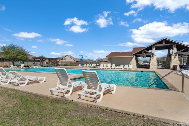 pool featuring a patio area and fence