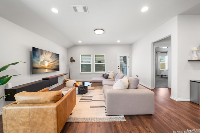 living room with visible vents, baseboards, lofted ceiling, recessed lighting, and wood finished floors