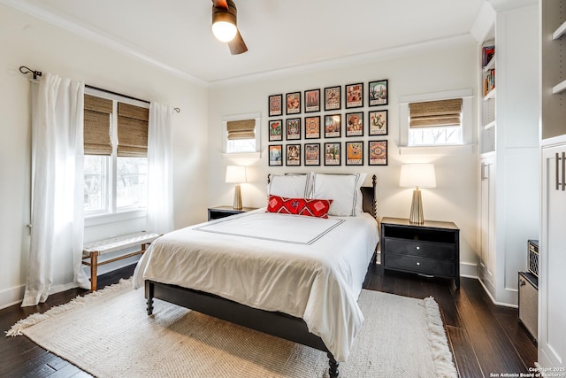 bedroom featuring dark wood-style floors, ceiling fan, baseboards, and ornamental molding