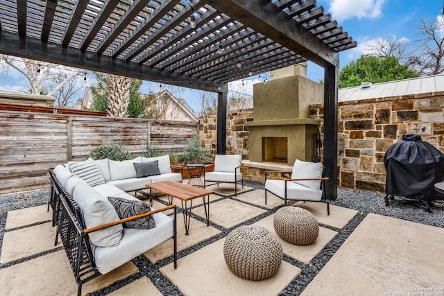 view of patio / terrace with area for grilling, an outdoor living space with a fireplace, a fenced backyard, and a pergola