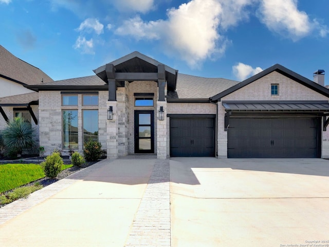 view of front of home featuring driveway, brick siding, roof with shingles, and an attached garage