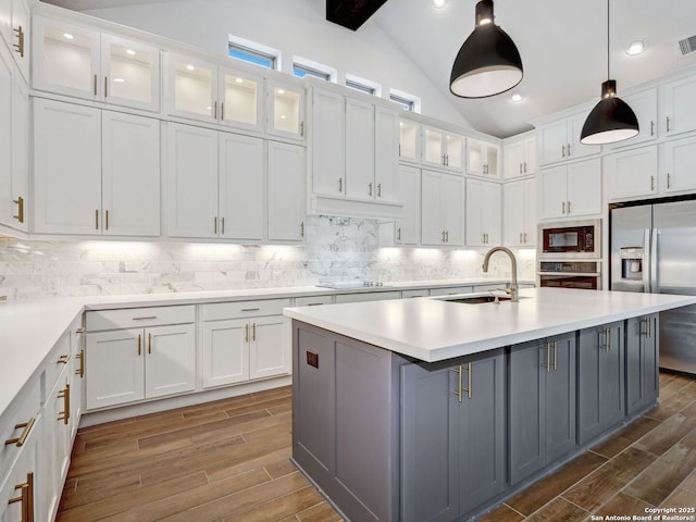 kitchen featuring lofted ceiling with beams, a sink, gray cabinetry, black appliances, and white cabinetry