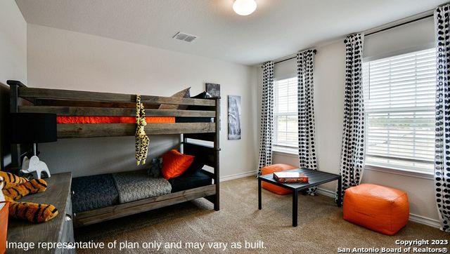 bedroom with baseboards, visible vents, and carpet floors