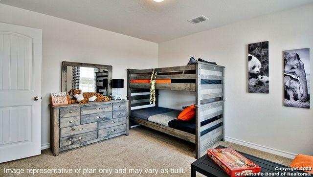 carpeted bedroom featuring visible vents and baseboards