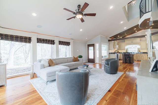 living area featuring light wood-type flooring, ornamental molding, recessed lighting, lofted ceiling, and ceiling fan