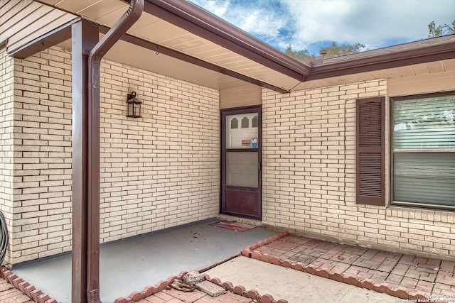 property entrance featuring brick siding