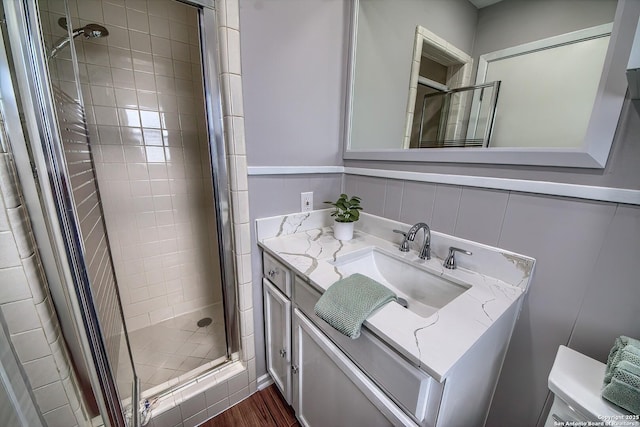 bathroom featuring a shower stall and vanity