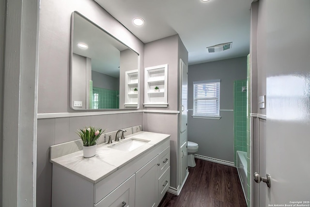 full bath with visible vents, baseboards, toilet, wood finished floors, and vanity