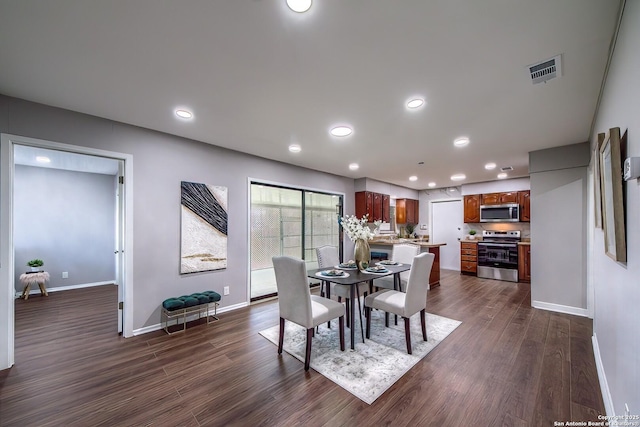 dining room with dark wood-type flooring, recessed lighting, baseboards, and visible vents