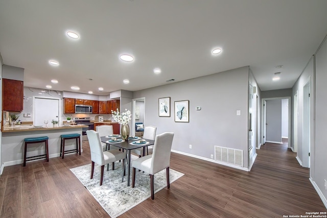 dining room with visible vents, recessed lighting, baseboards, and dark wood-style flooring