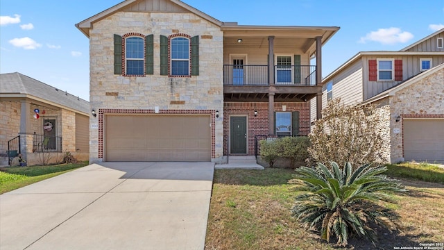 view of front of home with a balcony, driveway, an attached garage, stone siding, and brick siding