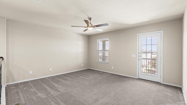 empty room with carpet floors, a textured ceiling, and ceiling fan