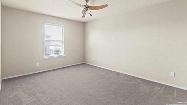 carpeted empty room with baseboards and ceiling fan