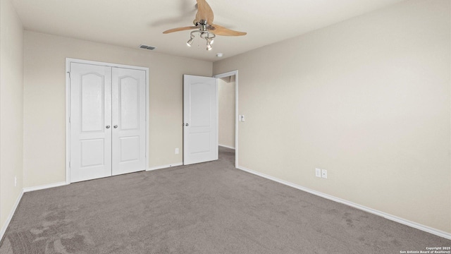 unfurnished bedroom with a closet, baseboards, carpet, and visible vents