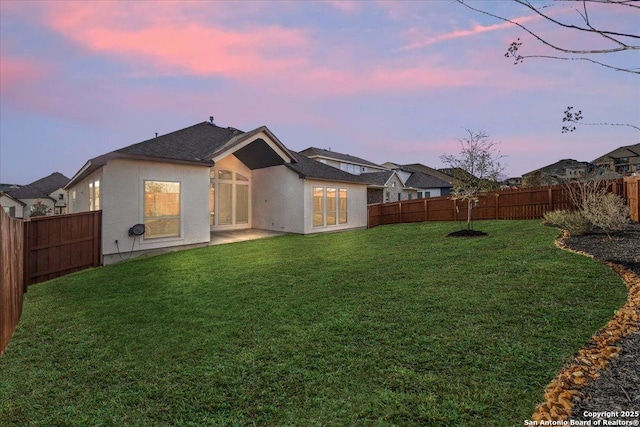 yard at dusk with a fenced backyard