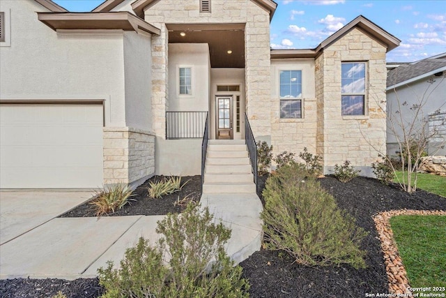 view of front of house featuring stone siding, stucco siding, and a garage